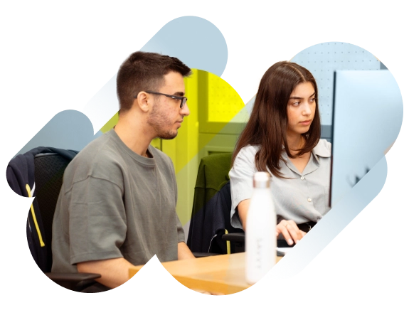 Two people are sitting at a desk working on a computer, with a water bottle on the table. The background features abstract shapes.